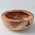 A thick, woodturned bowl with a highly-figured finish.