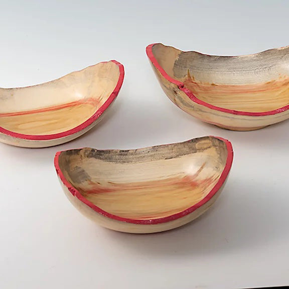 Three spalted maple woodturned bowls with natural edges, dyed pink.