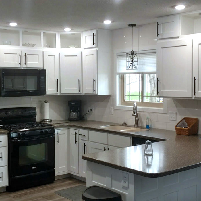 Bright white kitchen with custom cabinets and modern finishes